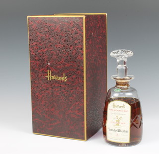 A Stuart cut glass decanter of 12 year old pure highland malt whisky, specially selected for Harrods (some signs of evaporation) 