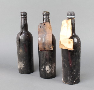 A bottle of 1935 port, a bottle of 1935 Smiths Woodhouse & Company vintage port and a bottle of Delaforce 1935 port, all unlabelled and some leakage 
