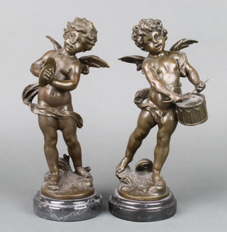 A pair of bronze figures of cherub musicians, raised on socle bases 30cm h x 10cm diam. 