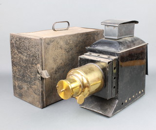 A magic lantern/projector contained in a Japanned and gilt metal case, converted for use with electricity, complete with carrying case   