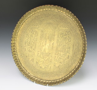 A circular engraved Persian brass charger decorated figures 48cm diam. 