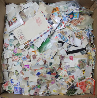 A large box of loose world stamps and first day covers