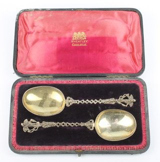 A pair of 19th Century Dutch silver apostle spoons with angel terminals, open stems and gilt bowls, 126 grams, cased