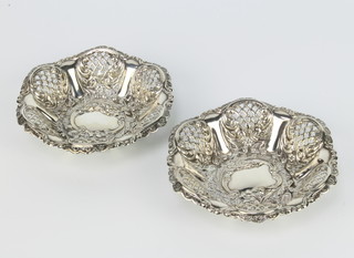 A pair of Victorian repousse and pierced silver bon bon dishes decorated with flowers London 1897, 102 grams 