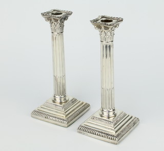 A pair of Edwardian silver Corinthian column candlesticks on stepped bases London 1906, maker Goldsmiths & Silversmiths Company, 23cm 