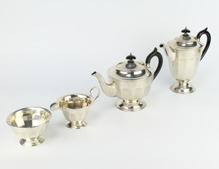 A silver 4 piece tea and coffee set of panelled form with ebony mounts, Sheffield 1933 and 1934, gross weight 1146 grams  