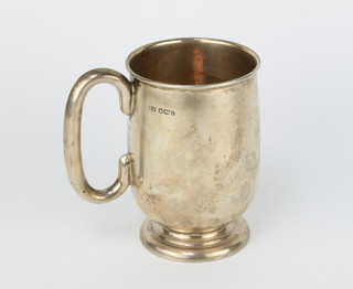 A silver mug with presentation inscription and C handle, 329 grams