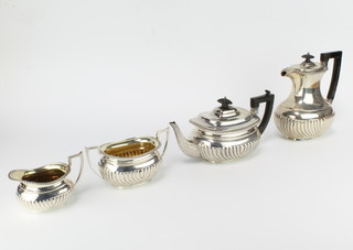 An Edwardian Scottish silver 4 piece tea and coffee set with demi-fluted decoration and ebony mounts, Edinburgh 1905, gross weight 1590 grams 
