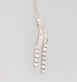 An 18ct white gold diamond double drop necklace on a do. chain 