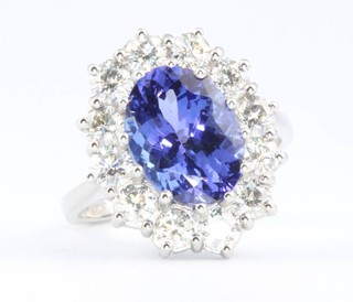 An 18ct white gold oval tanzanite and diamond ring, the centre stone approx. 5ct surrounded by brilliant cut diamonds approx 1.8ct, size P 