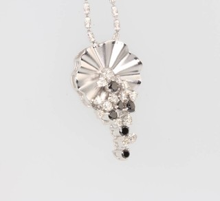 An 18ct white gold diamond and black diamond fancy pendant on a do. chain 