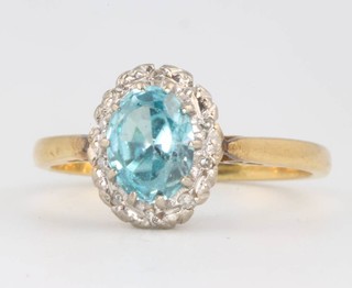 An 18ct yellow gold oval topaz and diamond cluster ring, the centre stone approx. 0.85ct the diamonds approx. .08ct, size L 1/2 