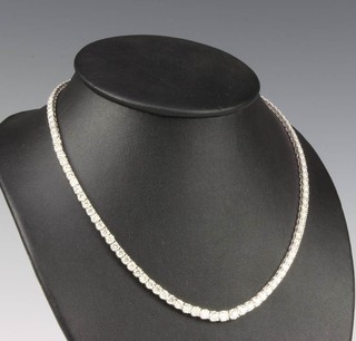 An 18ct white gold graduated diamond line necklace, 22cts, 44cm 