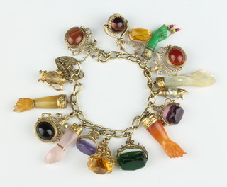 A 9ct yellow gold charm bracelet with 16 gold mounted hardstone charms 