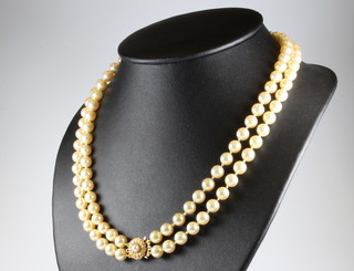 A double strand of cultured pearls with a 9ct yellow gold pearl set clasp, 96cm 