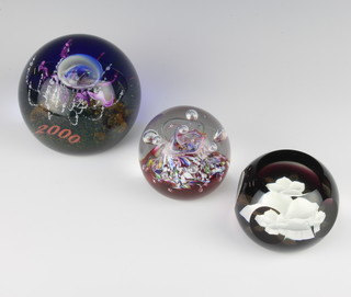 Three Caithness glass paperweights  - Myriad 7cm, Millenium Voyage 2000 134/250 10cm and faceted White Rose Xmas '84 7cm, all boxed