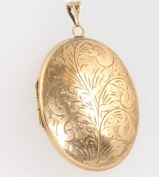 A 9ct yellow gold oval chased locket, gross 19.6 grams