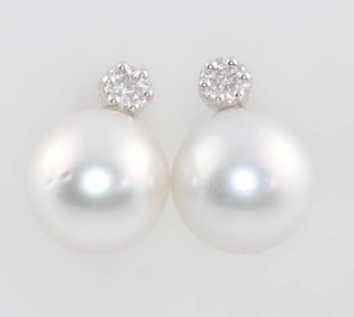 A pair of 18ct white gold diamond and south sea pearl ear studs