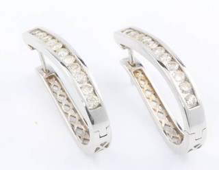 A pair of 14ct white gold channel set diamond ear clips 0.6ct 