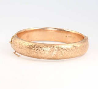 A 9ct yellow gold chased hollow bangle 15.4 grams