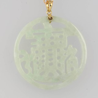 A pierced and carved Chinese hardstone pendant hung on a 9ct yellow gold chain 