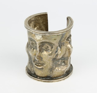 A cast silver bangle with mask decoration 150 grams