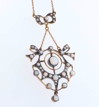 An Edwardian style opal seed pearl and diamond pendant on a gilt chain 