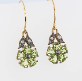 A pair of gold diamond and peridot daisy drop earrings 