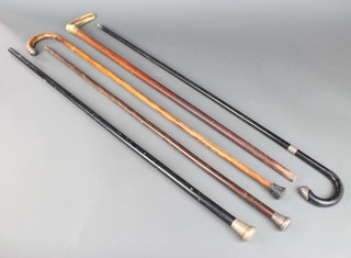 A silver mounted walking cane, 2 do. walking sticks and 2 others 