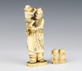 A Japanese Meiji period ivory Okimono of a standing man holding a grotesque figure in his hand, signed 13cm, a do. Netsuke of a seated figure with Hotie 3cm 