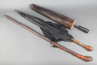 An Edwardian parasol with silver collar, a Japanese ditto and a carved cane