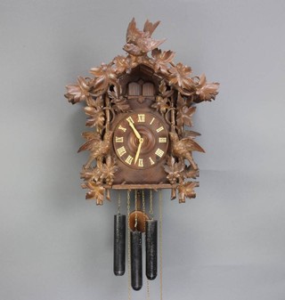 A 19th Century Black Forest double cuckoo clock with bone handles contained in a carved wooden case 
