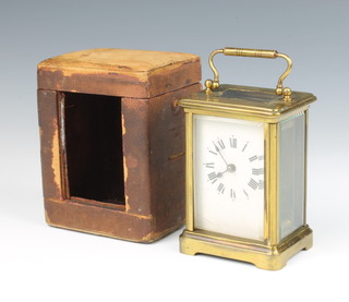 A French carriage timepiece with enamelled dial and Roman numerals contained in a gilt metal case 11cm x 7.5cm x 5.5cm 
