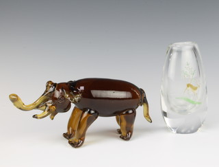 A Kosta Boda glass vase decorated with a deer in coloured enamels 12cm together with an amber glass figure of an elephant 20cm 