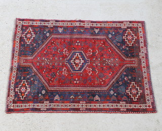 A red and blue ground Afghan rug with central medallion 163cm x 119cm, there is slight damage to the edge 