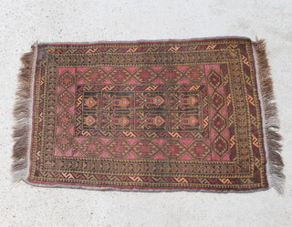 A tan and brown ground Persian rug with central medallion and multi-row borders 50cm x 86cm 