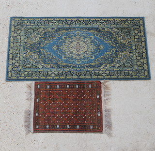 An orange and brown ground Persian slip rug with all over geometric design 67cm x 49cm together a blue ground Persian design Axminster rug 137cm x 69cm 