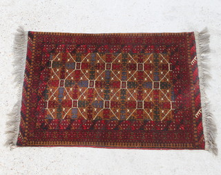 A brown and red ground Persian rug with geometric designs 114cm x 82cm 