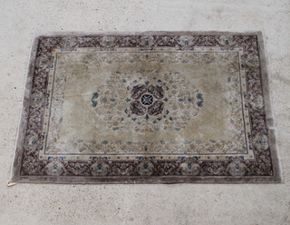 A cream and brown Chinese "silk" rug with central medallion 185cm x 122cm  