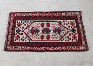 A white, red and blue ground Turkey carpet with diamond shaped medallion within multirow borders 200cm x 112cm 