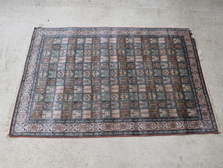 A pink and blue ground Persian carpet, the centre formed of 204 squares with floral decoration 270cm x 188cm 