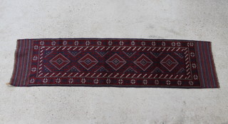 A red and blue ground Meshwani runner with 5 diamonds to the centre within multirow border 252cm x 66cm 