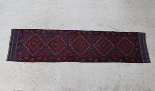 A red and blue ground Meshwani runner with 5 diamonds to the centre within a multi row border  264cm x 67cm 