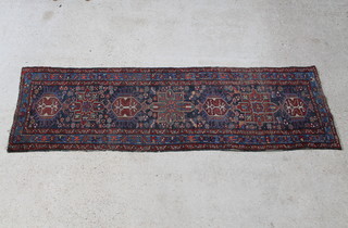 A blue and brown ground Persian Heriz runner with 4 diamonds to the centre 291cm x 87cm 