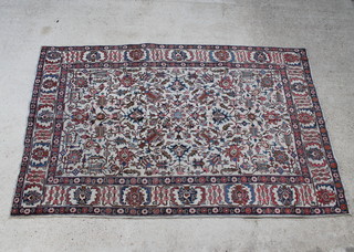 A white and red ground Tabriz rug with floral decoration 295cm x 189cm 