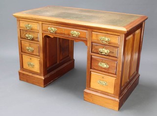 An Edwardian kneehole pedestal desk with inset green leather writing surface above 1 long and 8 short drawers with brass swan neck drop handles 77cm h x 121cm w x 68cm (this desk is in one piece) 