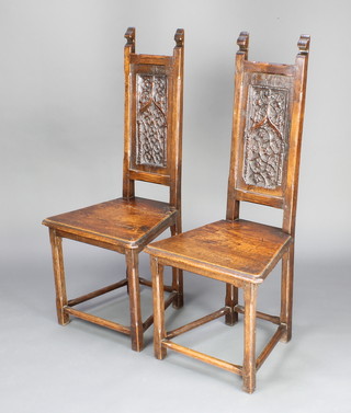A pair of Victorian 17th Century style carved oak hall chairs with carved backs and solid seats, raised on chamfered supports with box framed stretcher