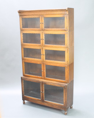 A Minty 1930's 5 tier bookcase with panelled doors, raised on turned supports 171cm h x 90cm w x 29cm d
