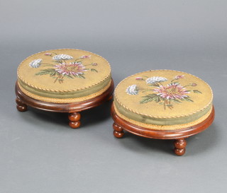 A pair of Victorian circular mahogany stools raised on turned supports with bead work upholstery 14cm x 32cm diam. 
