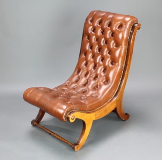 A Georgian style mahogany show frame chair upholstered in brown buttoned leather, raised on outswept supports 